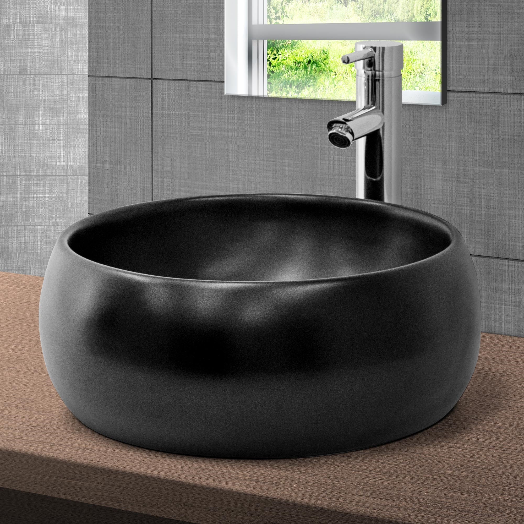 Rundes, schwarzes Waschbecken auf einem Holzuntergrund mit Wasserhahn.