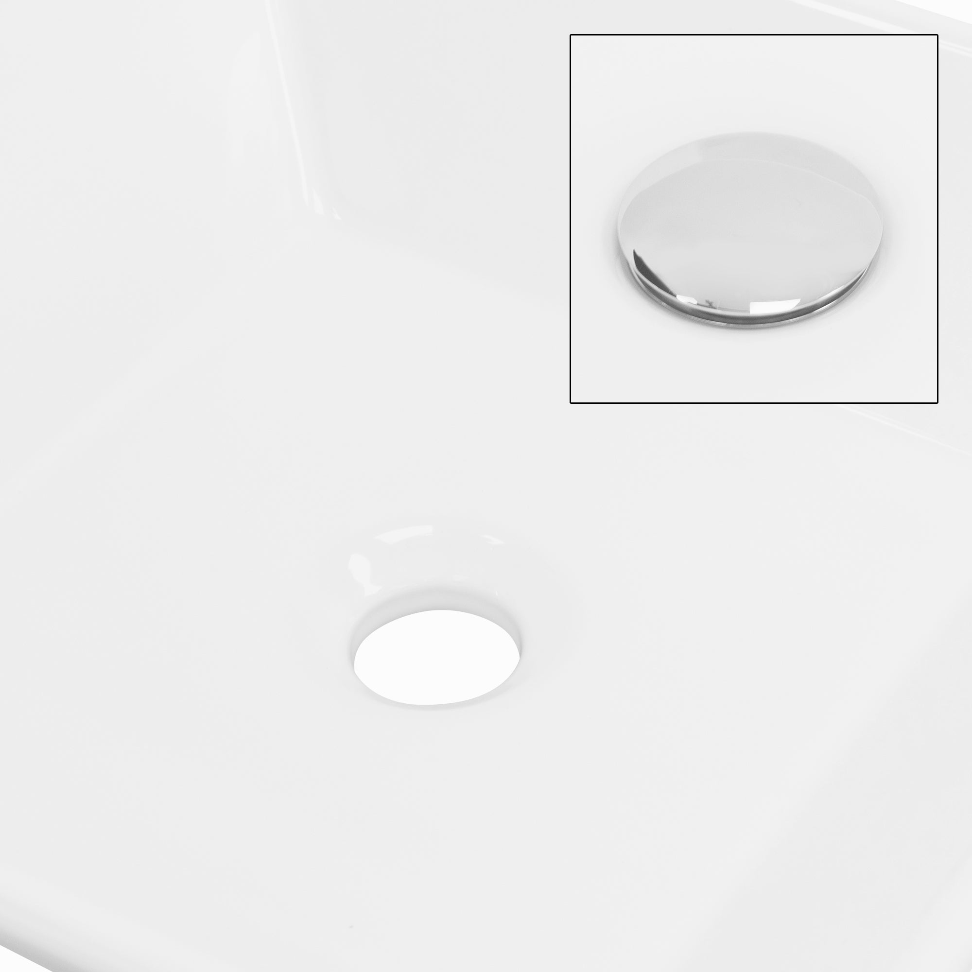 Weißes Waschbecken mit Abflussloch und glänzendem Überlaufdeckel.
