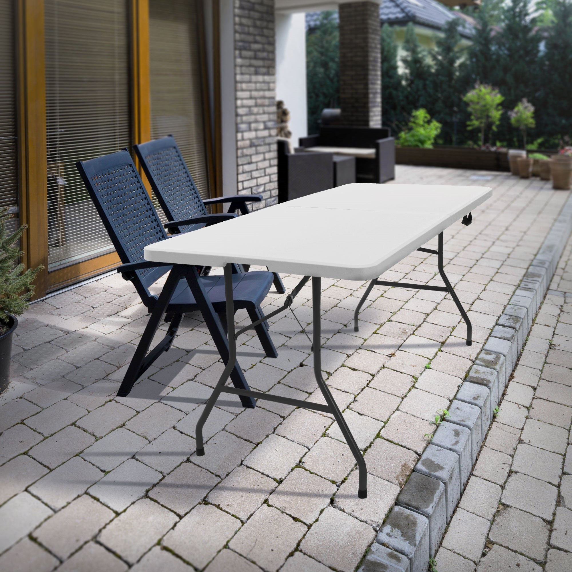 Table outdoors, next to a chair, on a paved floor.