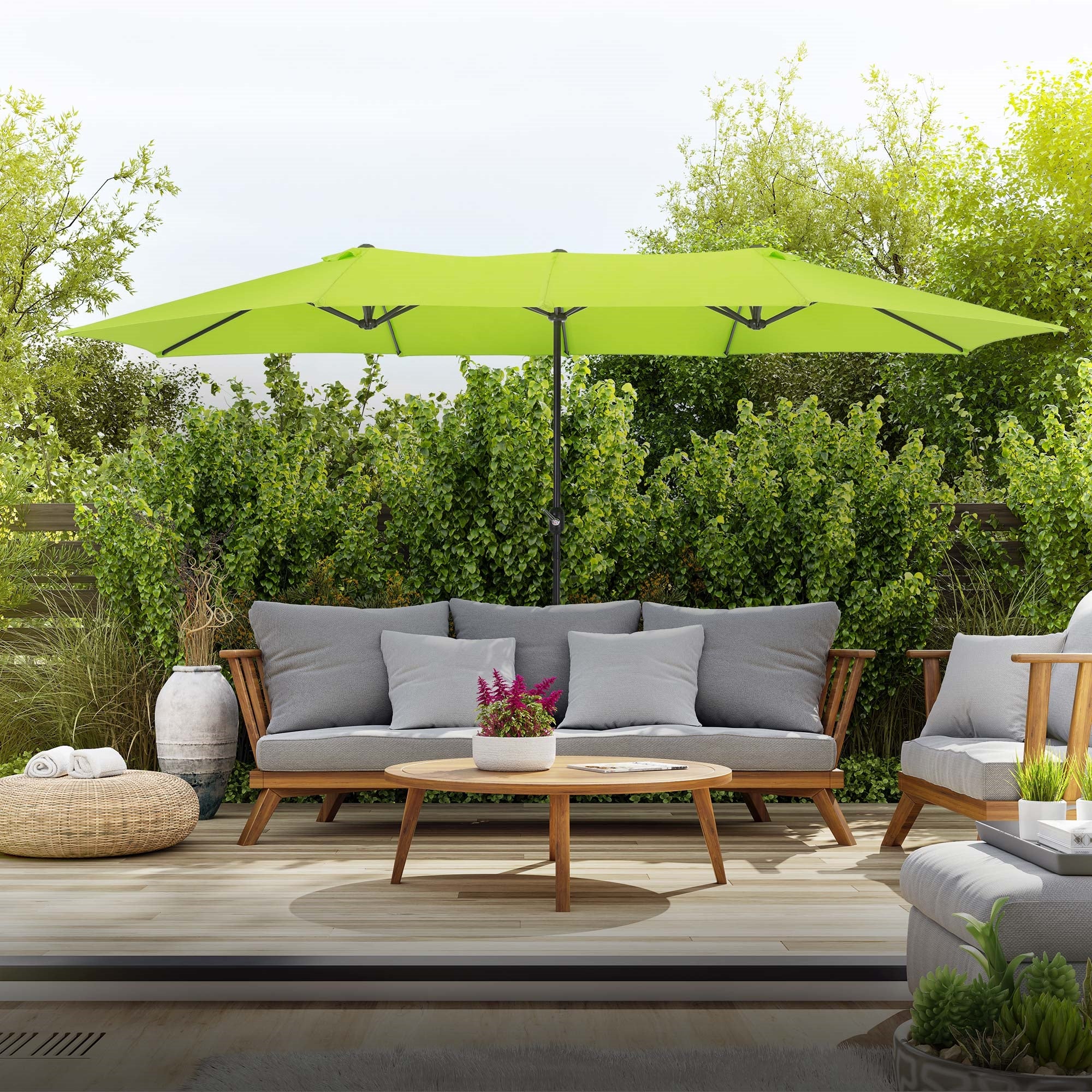 Groene parasol boven een zithoek in de tuin.