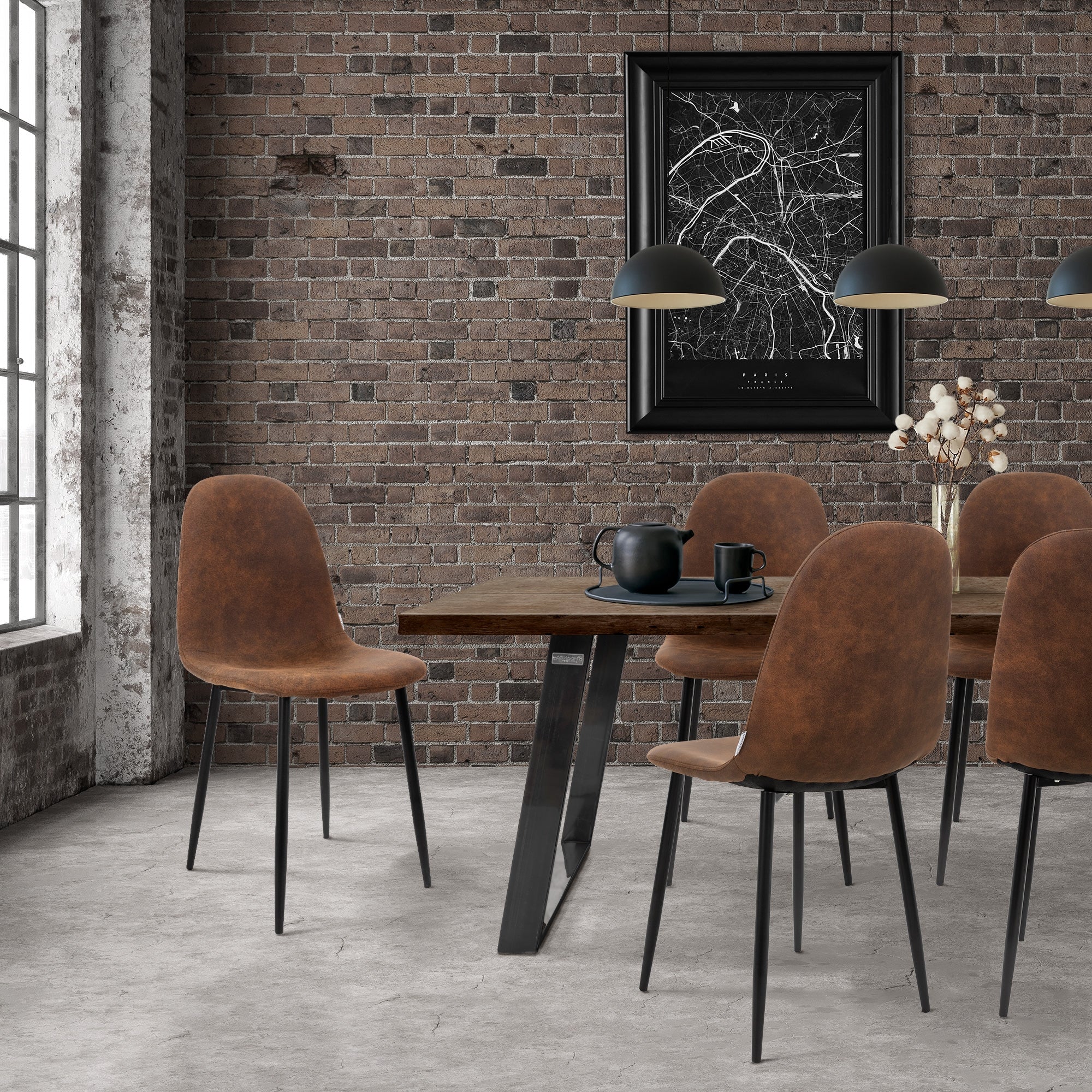 A dining room with a wooden table, four brown chairs, and a brick wall.