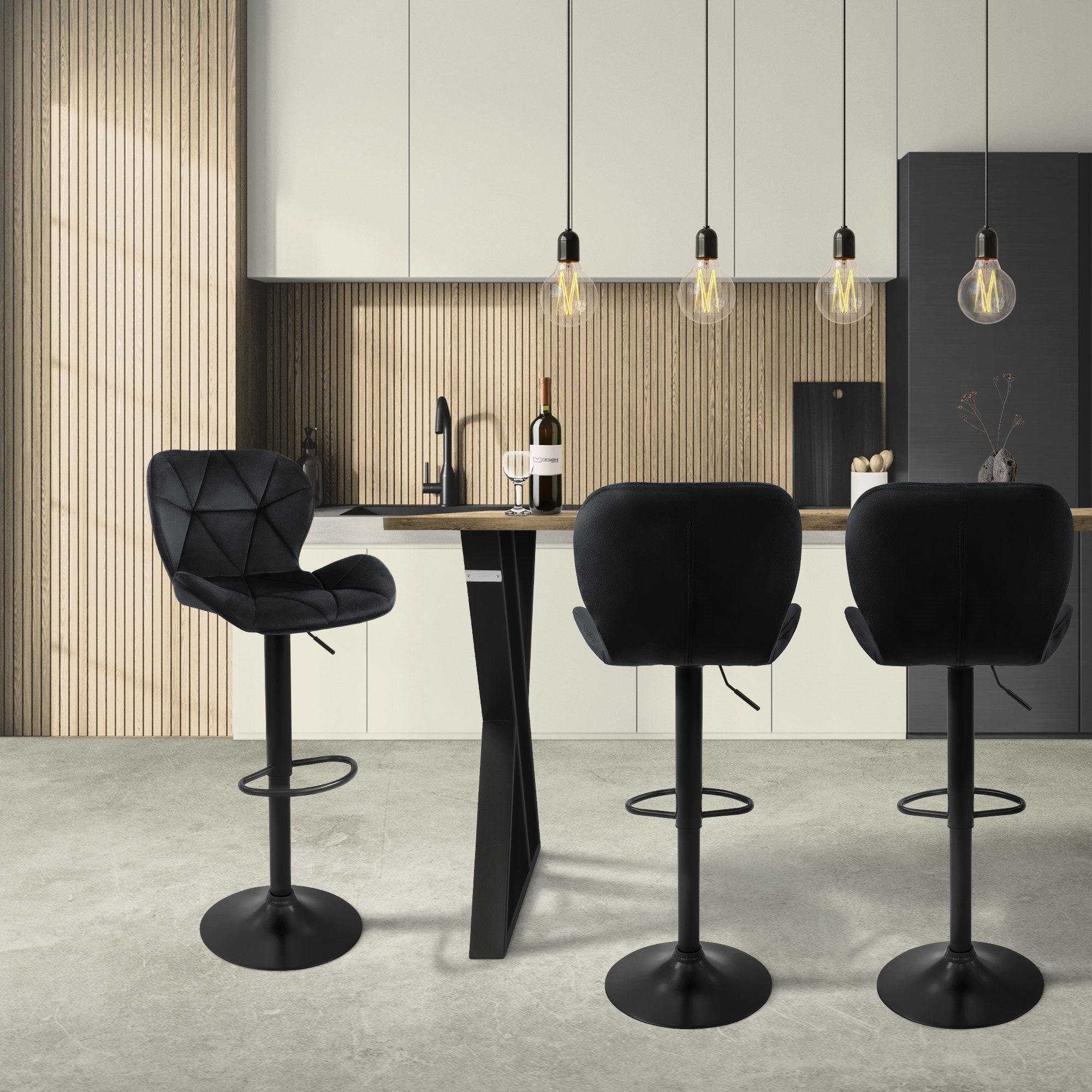 Modern kitchen with three black bar stools at a table and hanging lamps.