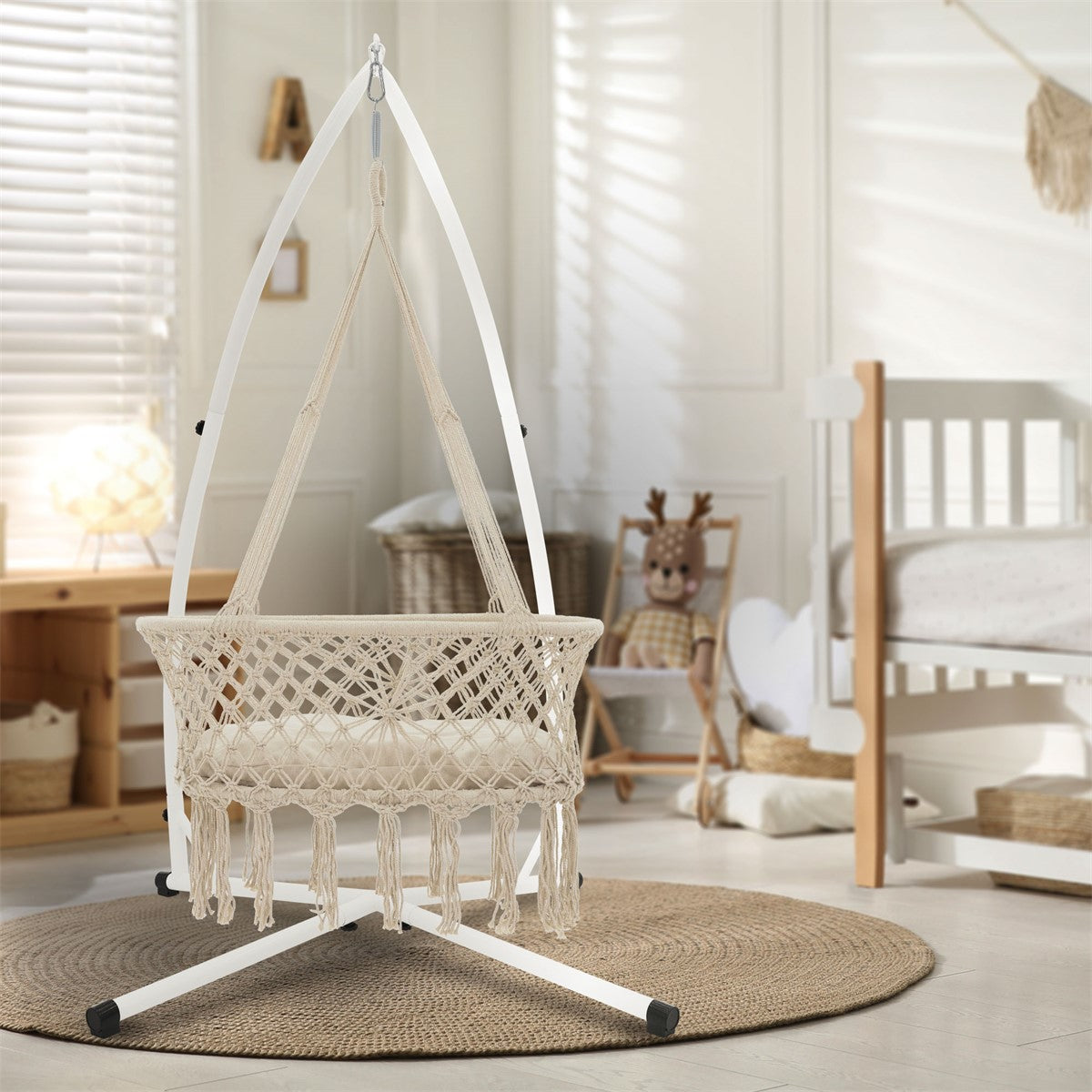 Hammock in a bright room with a cot in the background.