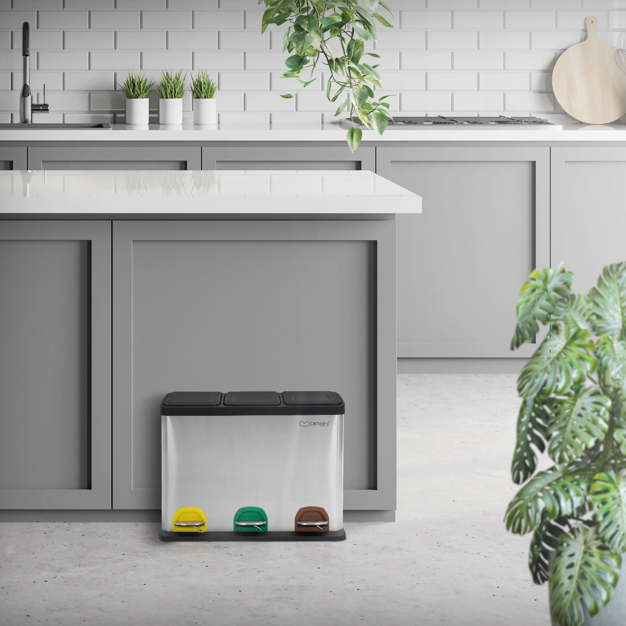 Waste separation system in a modern kitchen with plants and bright interior.