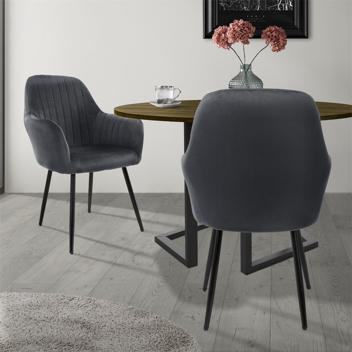 Two grey chairs at a round table on a light-coloured floor.