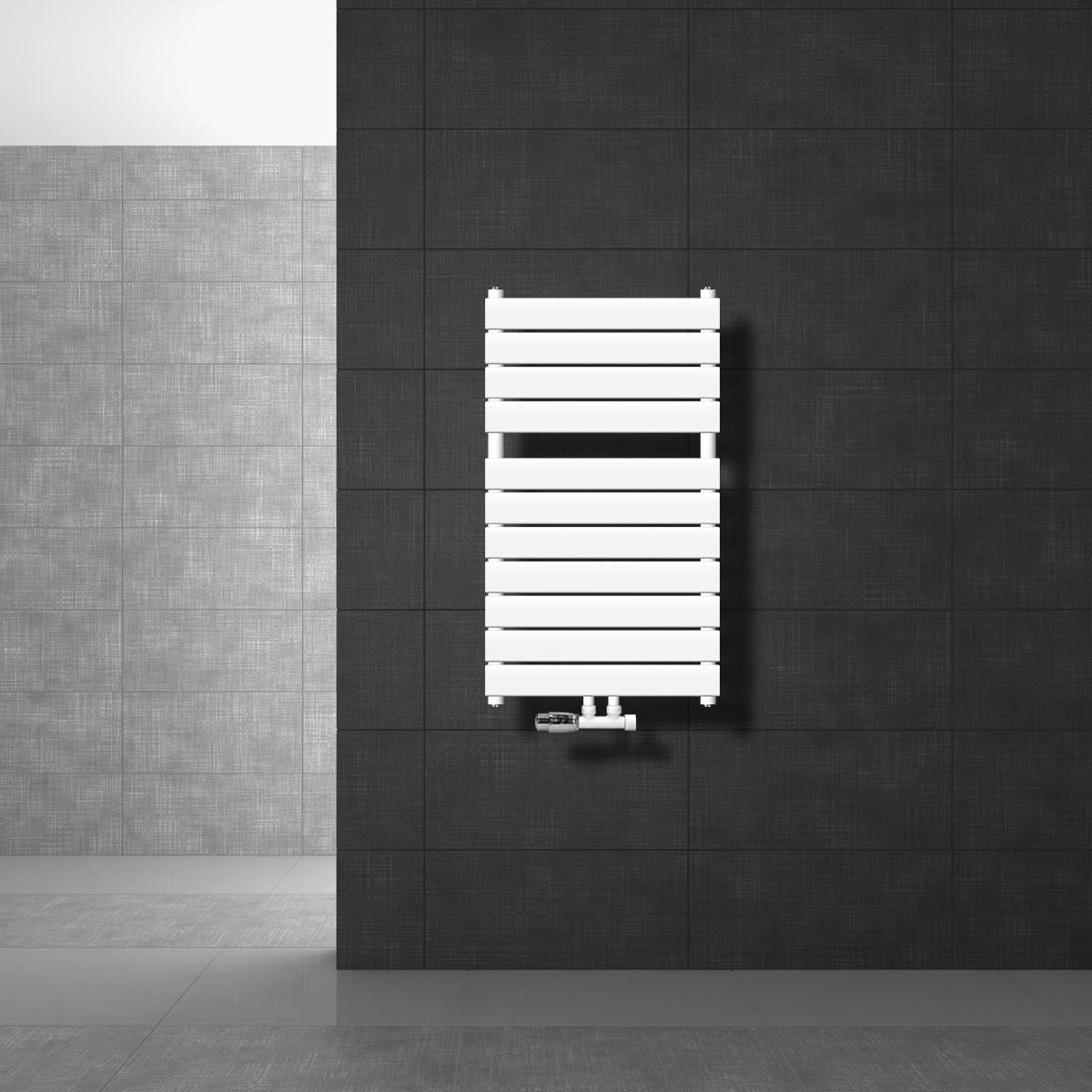 Witte radiator gemonteerd aan een donkere muur.