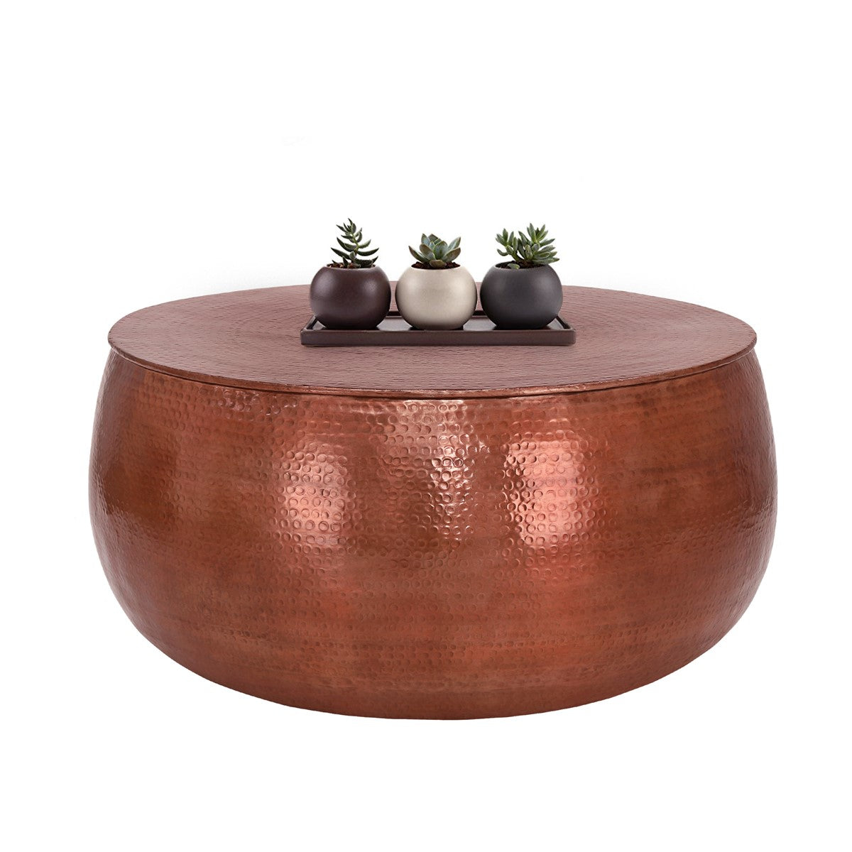 Round copper-coloured table with three small potted plants on it.