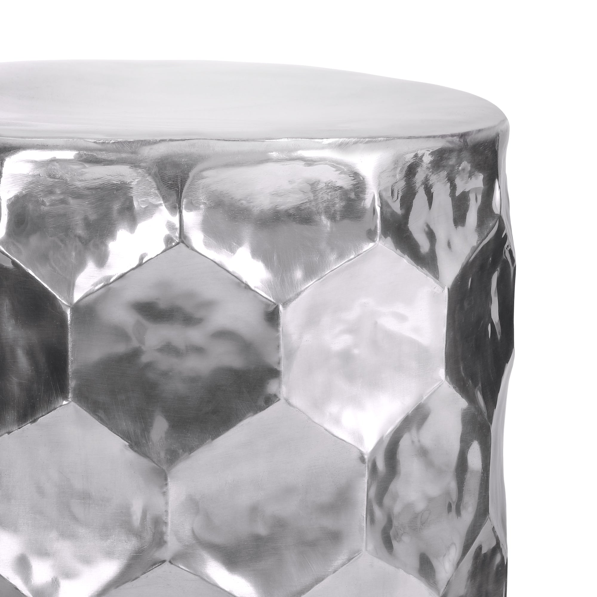 Round table with a silver-colored, faceted surface.
